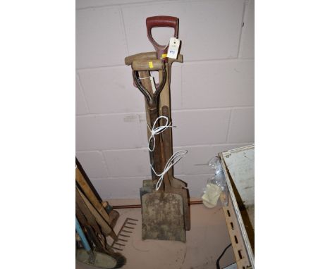 A bundle of garden tools, comprising: spades; a shovel; and a spit.