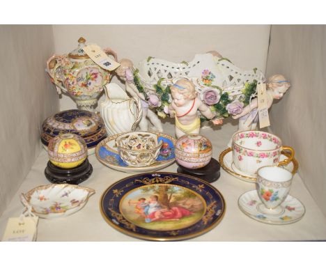 A damaged and repaired Continental oval pierced ceramic fruit bowl, supported by four putti; a Vienna cabinet plate decorated