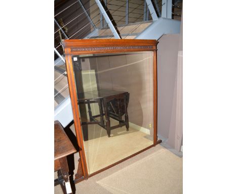 An early 20th Century overmantel mirror, the stained wood surround with reeded frieze, 140 x 126cms wide.