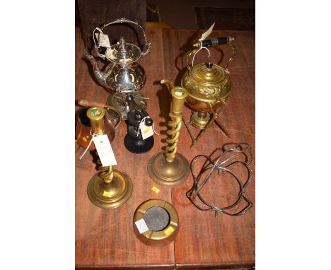 An EPNS tea kettle and stand; a brass tea kettle and stand; a cast iron nut cracker; a pair of brass spiral twist candlestick