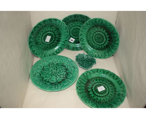Five green glazed ceramic plates, four impressed Wedgwood, one without a mark; and another leaf pattern similar plate by Wedg