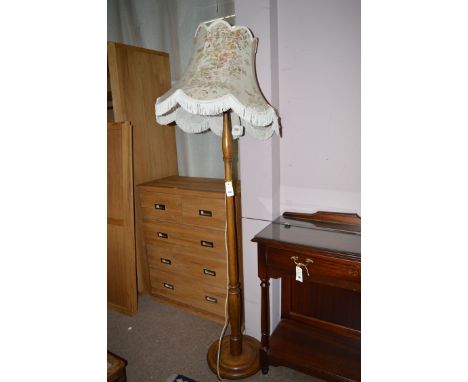 A stained wood standard lamp fitted floral shade.