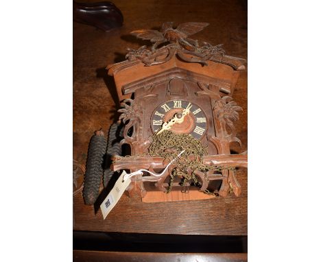 A German cuckoo clock with pinecone weights.