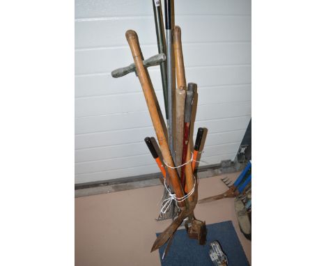 A bundle of garden tools, including: a pick; and a lawn edger.