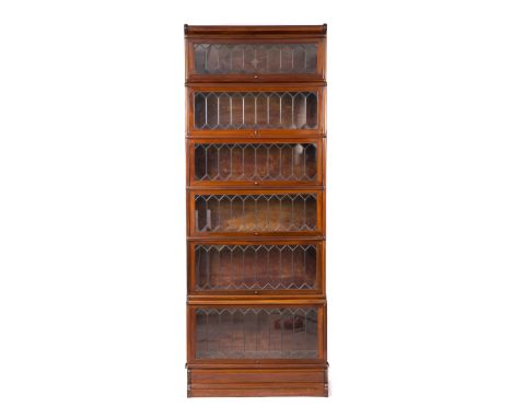 A GLOBE-WERNICKE MAHOGANY VENEERED FIVE SECTIONAL BOOKCASE, each section with a lead light glazed lift up panelled door label