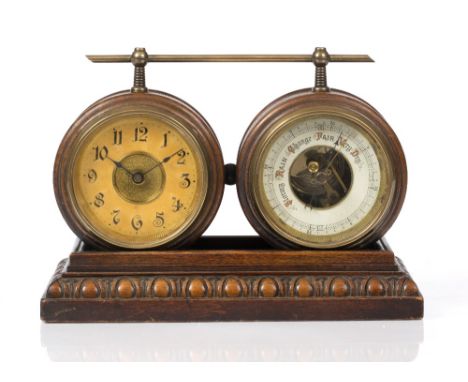 A LATE VICTORIAN CLOCK/BAROMETER with circular dials, carrying handle and in a carved oak case, 28cm wide