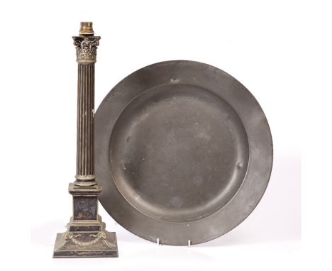 AN ANTIQUE PEWTER BROAD RIM CHARGER 42cm diameter; and a silver plated corinthian column table lamp on square base, 49cm high