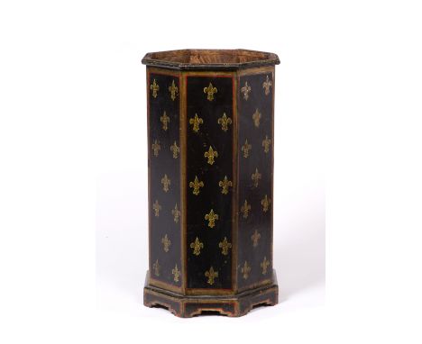 A PAINTED OCTAGONAL WOODEN STICK STAND with fleur de lys decoration on a black ground, 53cm high x 28cm across