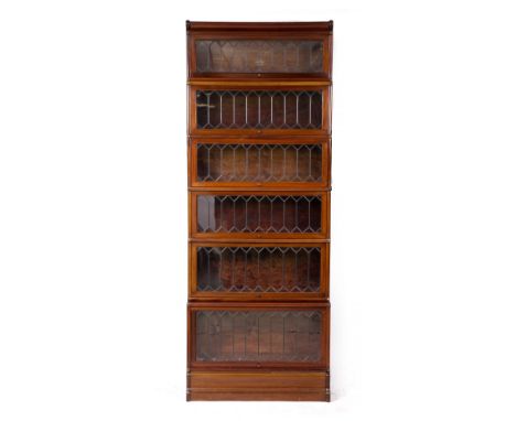 A GLOBE-WERNICKE MAHOGANY VENEERED FIVE SECTIONAL BOOKCASE, each section with a lead light glazed lift up panelled door label