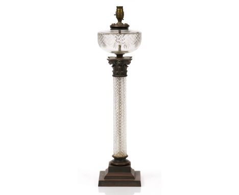 A VICTORIAN CUT GLASS AND METAL MOUNTED OIL LAMP converted to electricity and of classical column form on a stepped base, 67c