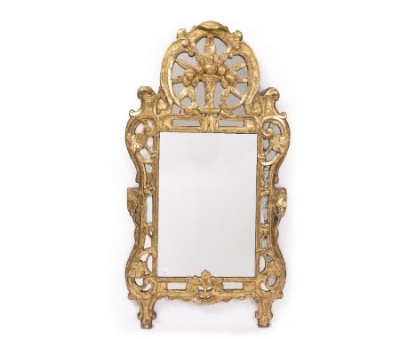 AN 18TH CENTURY GILTWOOD HANGING WALL MIRROR decorated with a trumpet vase of flowers within a scrolling mirrored border