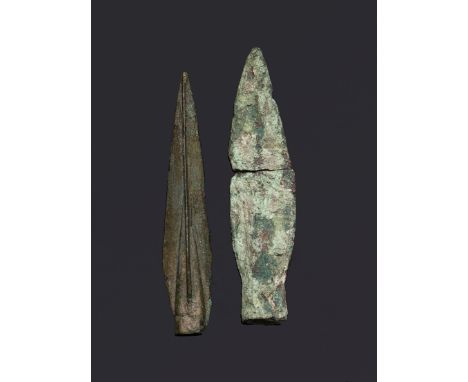 TWO ANCIENT METAL ARROW HEADS, one broken in two (2)