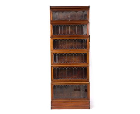 A GLOBE-WERNICKE MAHOGANY VENEERED FIVE SECTIONAL BOOKCASE, each section with a lead light glazed lift up panelled door label