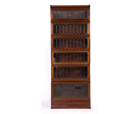 A GLOBE-WERNICKE MAHOGANY VENEERED FIVE SECTIONAL BOOKCASE, each section with a lead light glazed lift up panelled door label