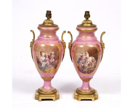 A PAIR OF FRENCH PINK PORCELAIN AND ORMOLU MOUNTED VASES, each painted with figures amused by a dancing dog and a panel of su