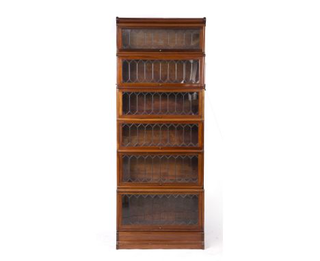 A GLOBE-WERNICKE MAHOGANY VENEERED FIVE SECTIONAL BOOKCASE, each section with a lead light glazed lift up panelled door label