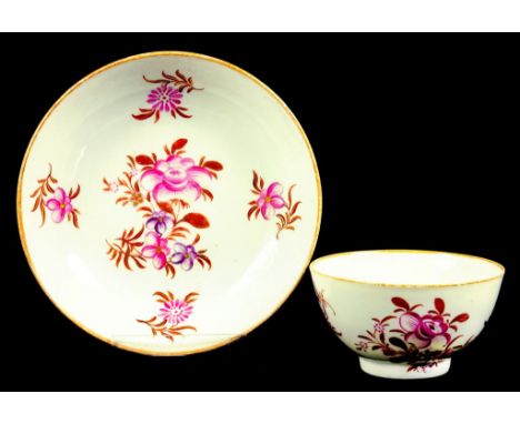 A WORCESTER TEA BOWL AND SAUCER PAINTED IN PURPLE, PUCE, BROWN AND GILT WITH STYLISED FLOWERS, CIRCA 1790