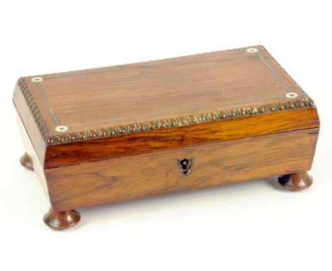 AN EARLY 19TH CENTURY ROSEWOOD CARD BOX OF SARCOPHAGUS SHAPE WITH WIRE STRINGING, CONTAINING FINELY PRINTED PLAYING CARDS, MI