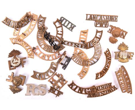 30 mostly brass Infantry shoulder titles, including large WM R-S, Queens Surreys, NF, Kings, L/grenade/F (x2), pair D.C.L.I.,
