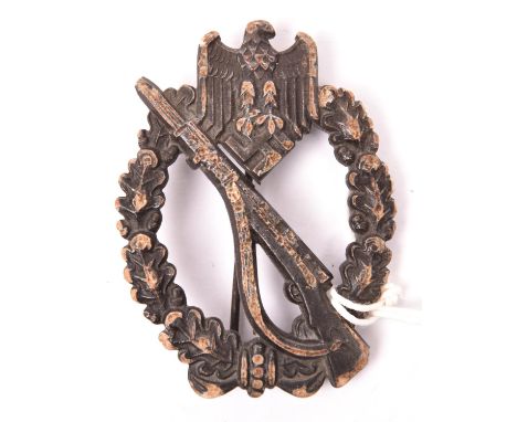A Third Reich Infantry Assault badge in bronze, of solid flat back zinc with round pin and maker’s mark “FLL” in trefoil (Fri