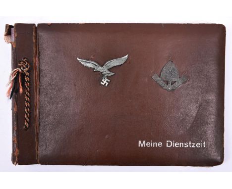 A Third Reich photograph album, the cover mounted with Luftwaffe metal cap eagle and RAD metal cap badge, and impressed “Mein
