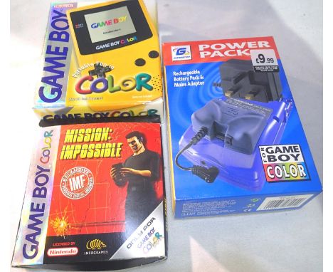 Nintendo Gameboy Colour: handheld game system, boxed, with an aftermarket power pack and Mission Impossible game, also boxed 