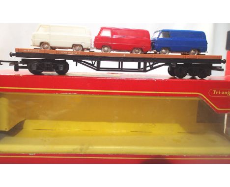 OO scale Triang/Hornby R563 Bogie bolster with three Ford vans, in excellent condition, box is poor. P&amp;P Group 1 (£14+VAT