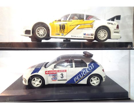 Two Ninco slot cars; Opel and Peugeot both in very good to excellent condition, plastic boxes. P&amp;P Group 1 (£14+VAT for t
