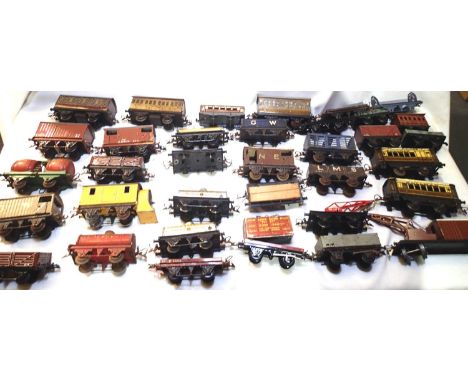 Thirty O gauge Hornby tinplate wagons and coaches including snow plough, crane, tankers etc mostly in fair condition/unboxed 