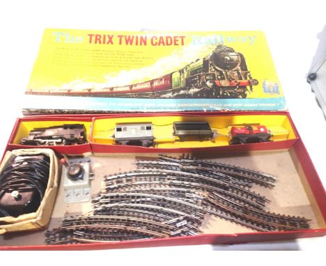 Trix Twin Cadet train set comprising 0.4.0 tank loco, plastic body, three tinplate wagons, three rail tracks and controller, 