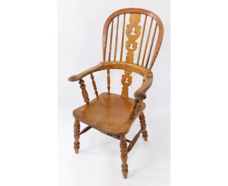 A Victorian oak yew and beech Windsor chair, solid saddle seat raised on turned legs, united by an H framed stretcher.