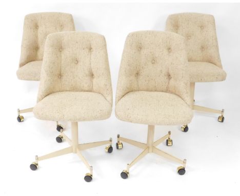 A set of four American late 20thC swivel single dining chairs, upholstered in button back oatmeal fabric, raised on a cream f
