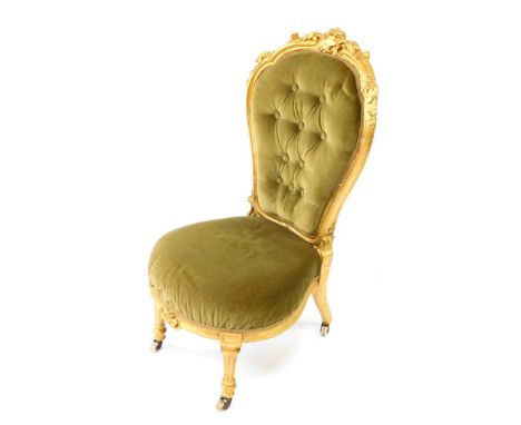 A Victorian parcel gilt balloon back nursing chair, upholstered in green button back velour with over stuffed seat, raised on