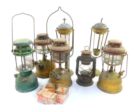 Four brass and enamel tilly lamps, smaller metal cased tilly type lamp, and a pair of brass gimbal candle lamps, possibly for