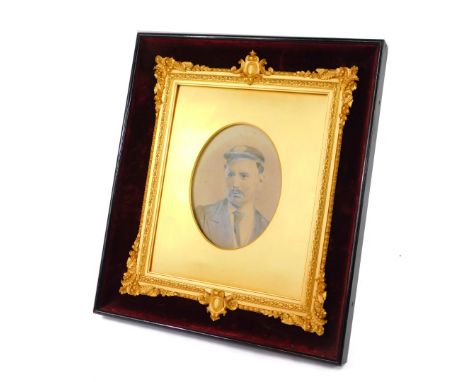 A Victorian gilt wood and gesso strut photograph frame, red velvet backed within an ebonised outer frame, decorated with cart