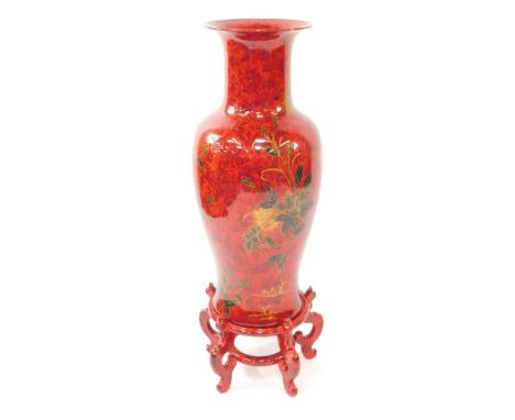 A Chinese red lacquer pottery vase, decorated with birds and blossom, on a circular stand on five scroll feet, total height 1