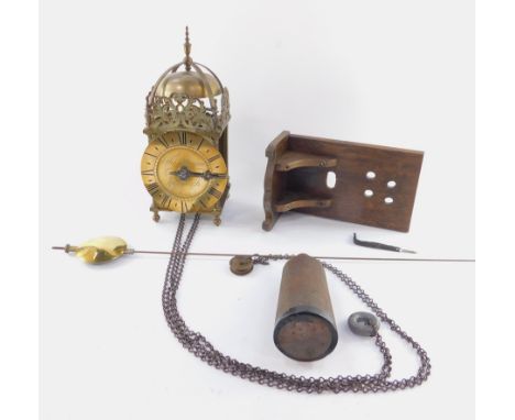 A 19thC brass hook &amp; spike lantern clock, engraved for Thos Moore, Ipswich, surmounted by a strapped bell, with four urn 