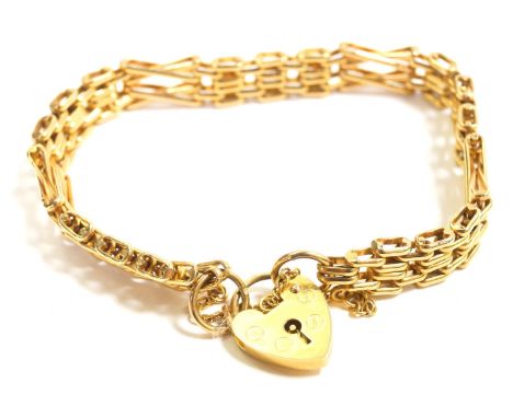 A 9ct gold three bar fancy link gate bracelet, on a heart shaped padlock clasp, with safety chain as fitted, 21.2g.