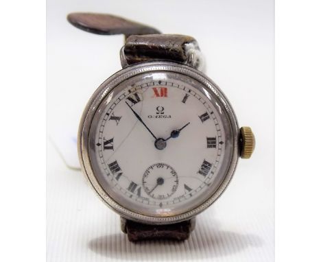 1920's Omega silver case manual wind wristwatch, the circular white enamel dial with black Roman numerals, red numeral at 12 
