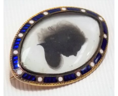 Georgian yellow metal, blue guilloche and white enamel oval shaped brooch inset with a silhouette of a lady, length 33mm 