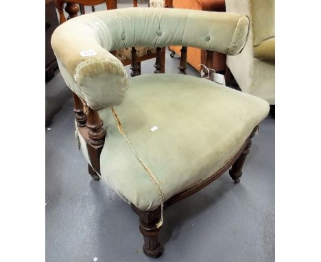 Edwardian oak framed upholstered tub chair, the C shaped button back upholstered rail over baluster turned supports, stuff ov