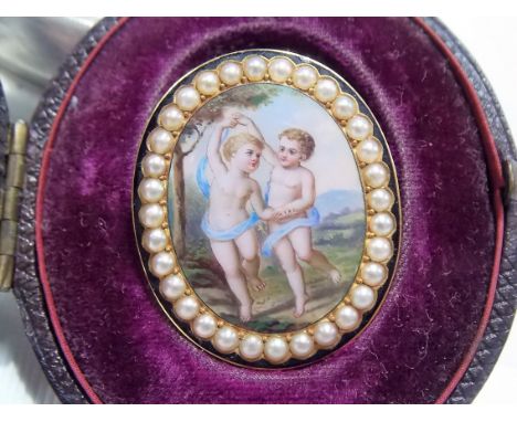 Victorian yellow metal oval enamel pearl set brooch, painted with two putti within a landscape bordered by seed pearls and bl