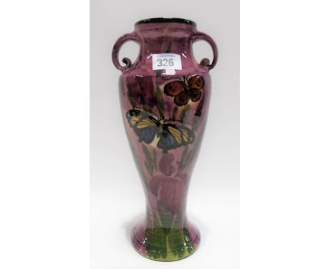 Lemon &amp; Crute Torquay ware twin handled baluster vase decorated with butterflies amongst foliage upon a purple ground, he