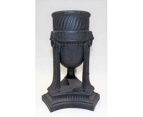 A 19th Century Wedgwood black basalt Neo Classical vase raised on triple supports with lion ring masks and on triform base.  