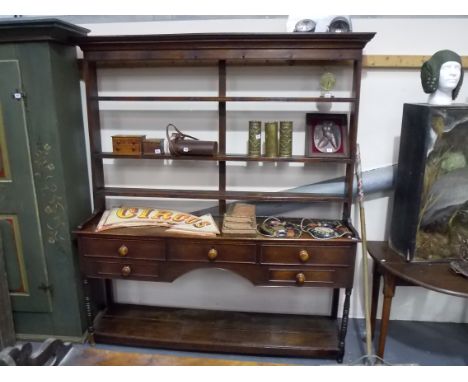 Late George III oak open back dresser, the raised open back with moulded cornice over three shelves, the two-tier base with t