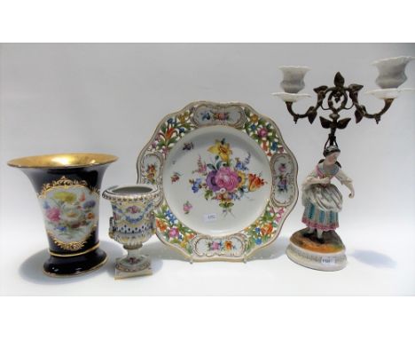 Four items of continental porcelain including a 20th Century Meissen flared vase painted with reserves of flowers upon a blue