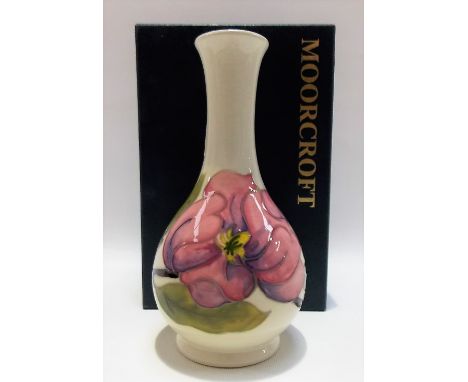 Moorcroft Pottery tubelined pink magnolia decorated bottle vase upon a cream ground, impressed marks to the base, height 16cm