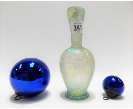 Two small blue glass witch balls together with an iridescent glass bottle vase with banded decoration, height 17.5cm