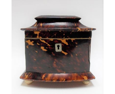 Good George III tortoiseshell bow front tea caddy, silver strung, raised on four ivory ball feet, width 13cm.