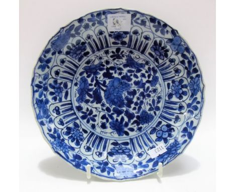 Chinese Kangxi period blue and white decorated shallow bowl, the moulded rim decorated with foliate panels and scrolls, the c